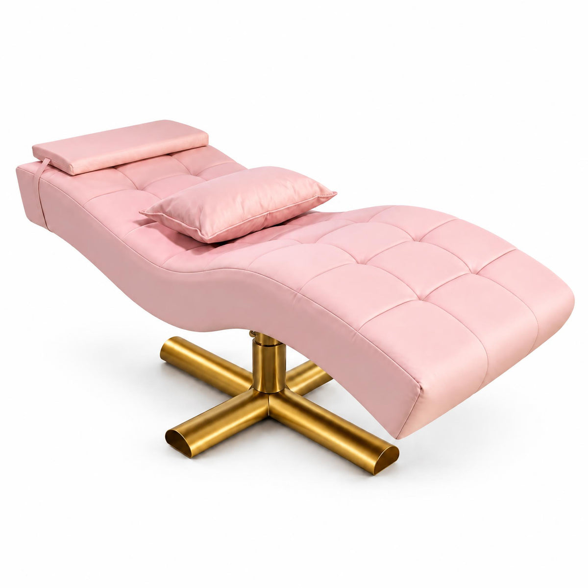 A pink tufted chaise lounge chair with a matching headrest pillow, set on a polished gold metal cross base against a solid white background.