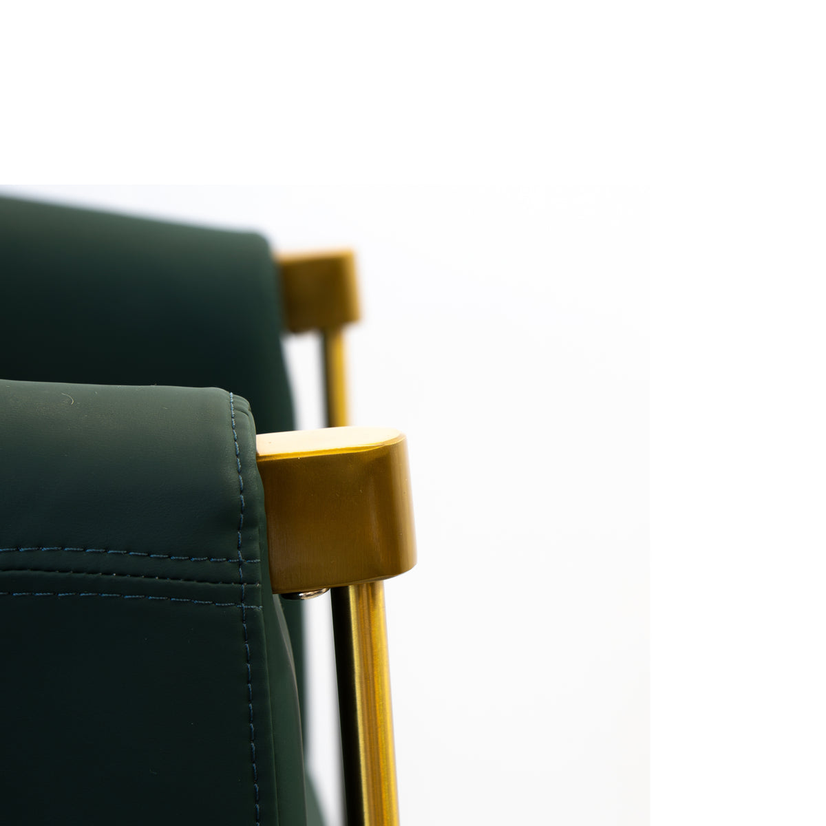 Close-up of the Karma Eden salon chair curved armrest and padded seat in emerald green