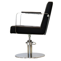 Side view of the Karma Lithgow salon chair in black showing the tufted backrest and silver base