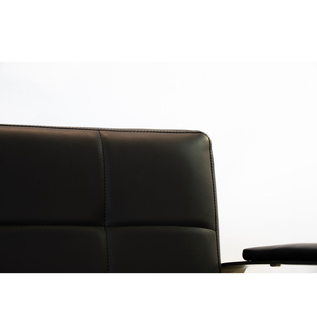 Close-up of the Karma Lithgow salon chair metallic armrest detail