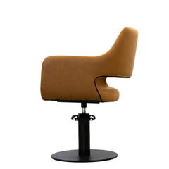 Side view of the Karma Mudgee salon chair in tan showing the open-back design and black round base