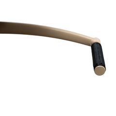 Close-up of the Karma Nundle salon chair in champagne showing the curved integrated armrest and upholstery