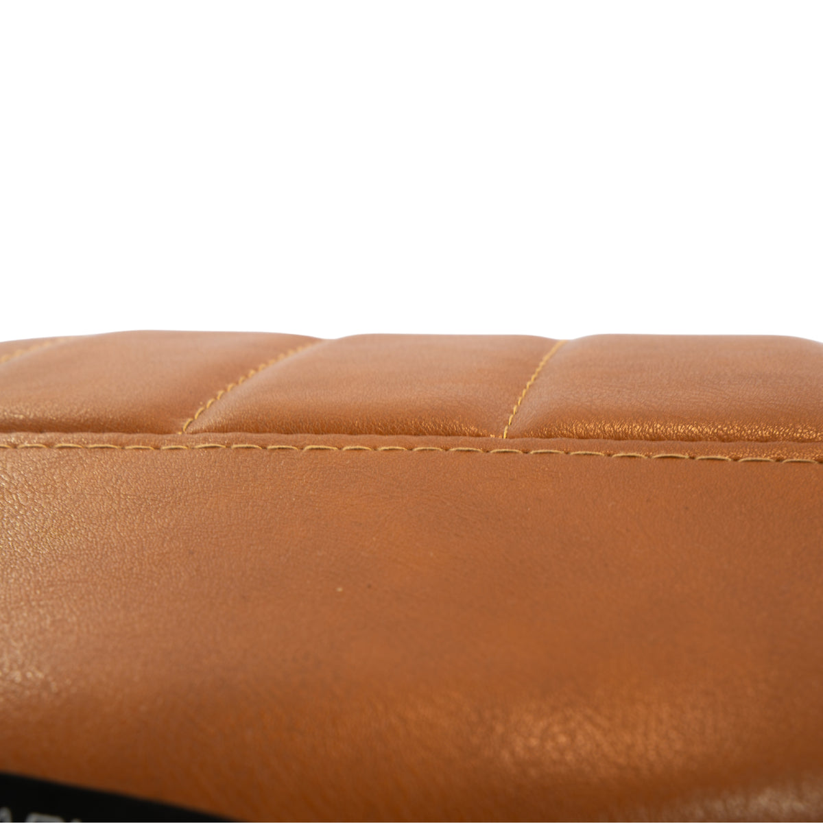 Close-up of the Karma Burnie salon stool tan padded seat with raised centre